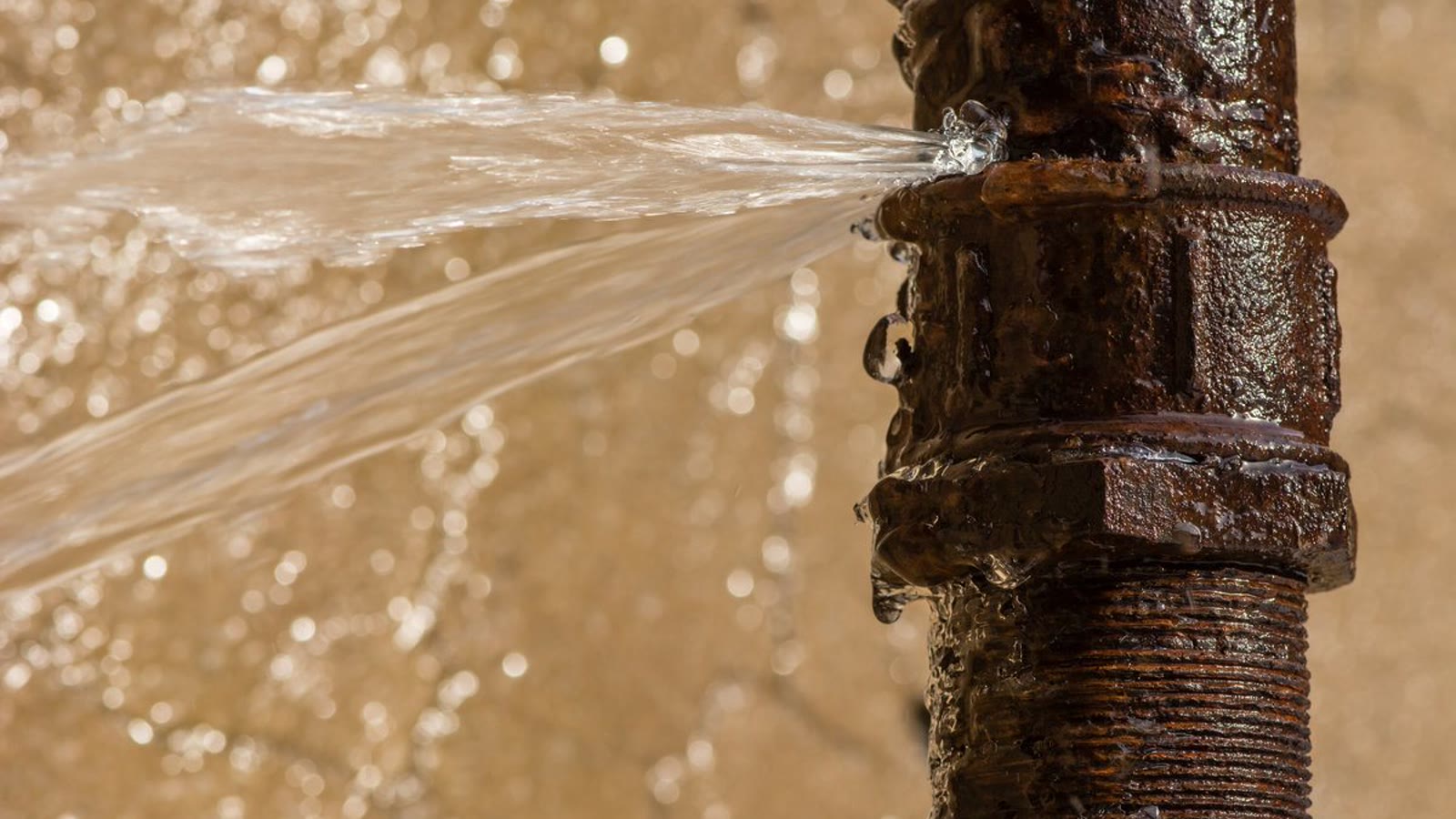 Water spraying from a corroded plumbing connection